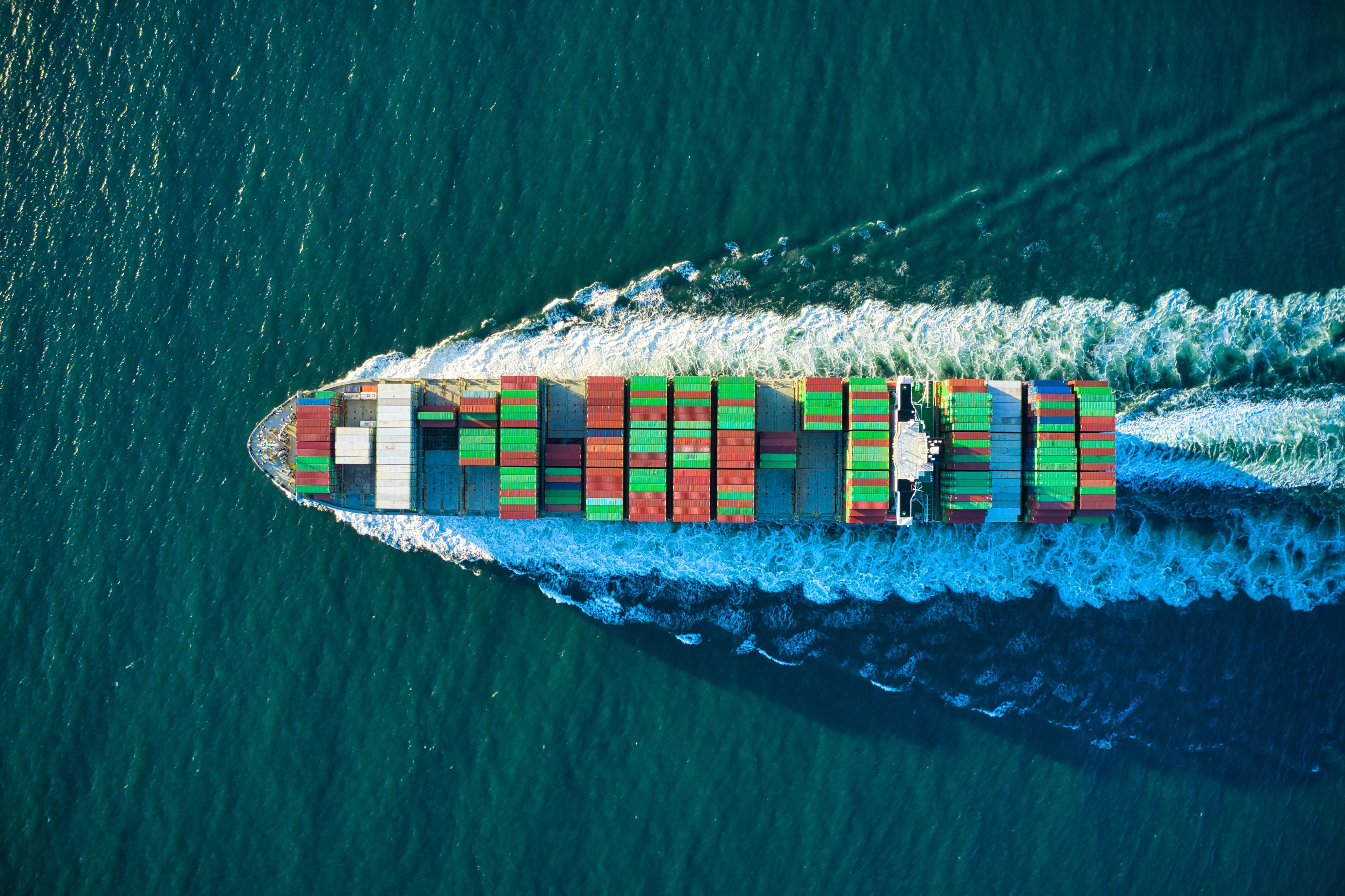 Aerial view of a cargo ship at sea, illustrating the time and distance saved when using the Middle Corridor for trade