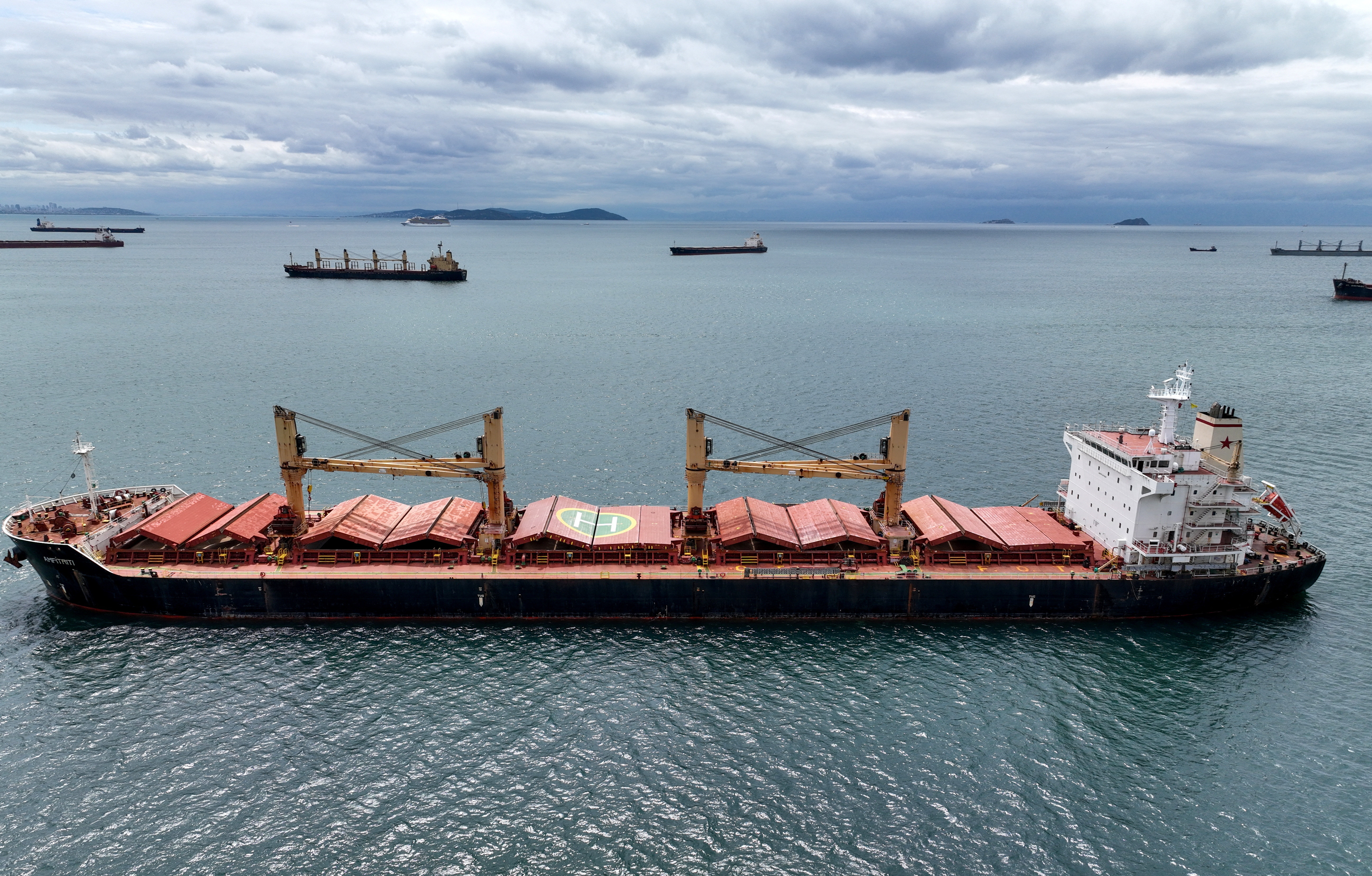 Amfitriti, a bulk carrier part of the Black Sea grain deal, and other commercial vessels wait to pass the Bosphorus strait off the shores of Yenikapi in Istanbul, Turkey.